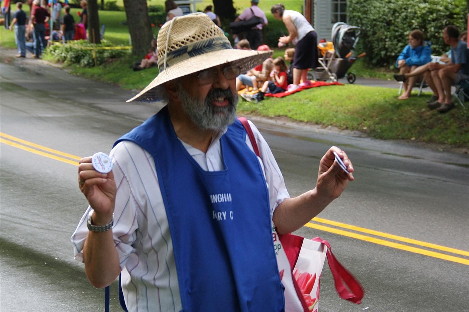 Members of the Hingham Rotary sell parade buttons